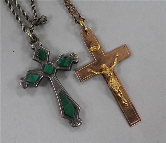 A gold crucifix pendant and a silver and malachite cross pendant.